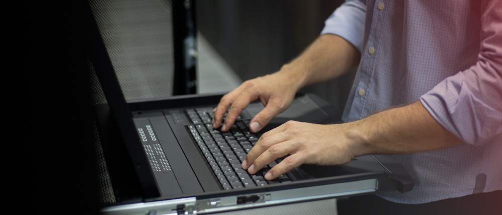 cutoff photo of person's hands typing on a laptop